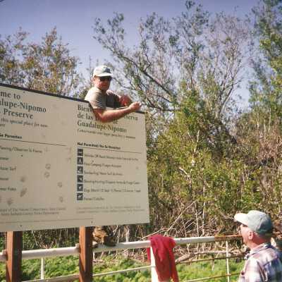 Installation of signs on beaches 3/1996. Pete St. John and Jim Neuschwander at Main St entrance gate.