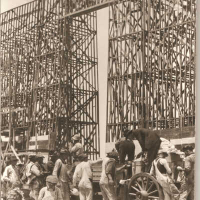 1923 workers lining up to receive food served off wagon into personal cups. Lunch break.