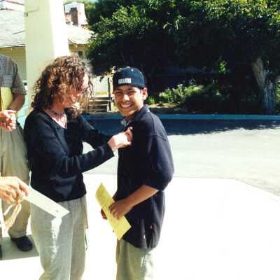 Conagh Duggan pins a Junior Docent at First Junior Docent Training June 2001; 4" x 6" color photograph