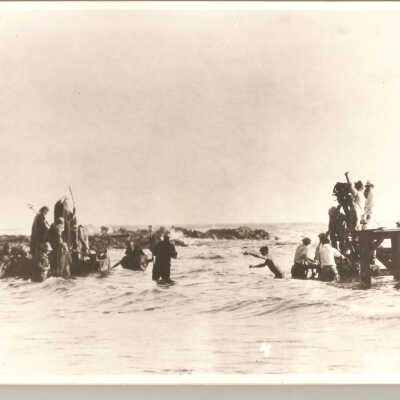 Cast and crew filming water scene. Cecil B. Demille shown filming scene.