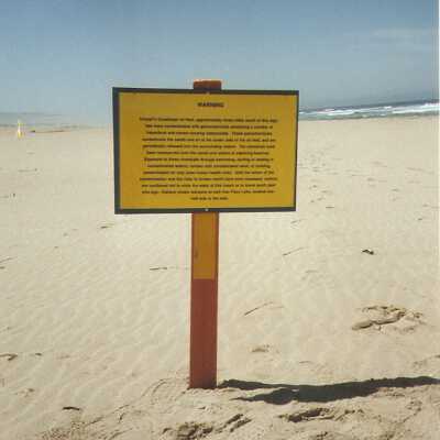 Unocal's warning sign on Oso Flaco Beach explaining contamination of sand, air, and water from diluent and oil leakage