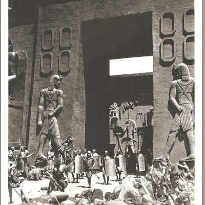 1923 movie clip. Soldiers guard Pharaoah exiting front gate while subject bow.
