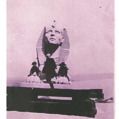 3 people get ready to pose in front of a sphinx taken from the set of The Ten Commandments.