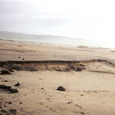 "Guadalupe Beach parking lot broken up by El Nino waves" February 1998