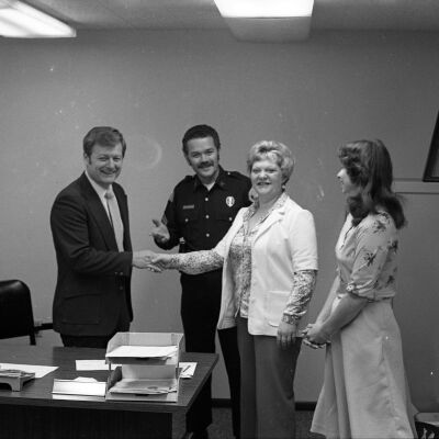 John Mansfield, Unidentified police officer, and Unidentified women, Date unknown: Frame 23