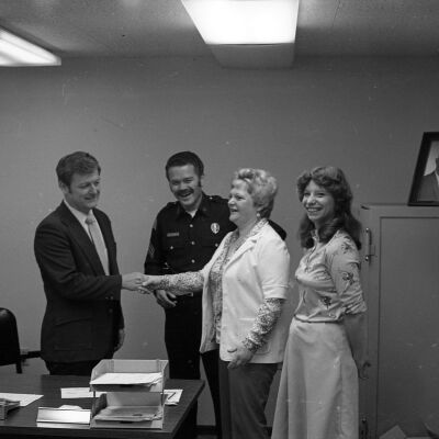 John Mansfield, Unidentified police officer, and Unidentified women, Date unknown: Frame 24