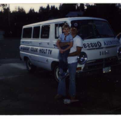 Denzil Richard Holt with son, Darren, in front of Holt company van.