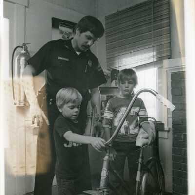Police Officer David Johnson with 2 boys and a bike