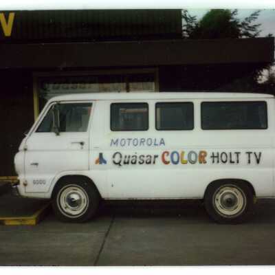 Holt Radio & TV company van parked in front of Holt business.