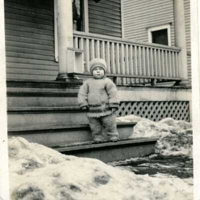 Unidentified child on steps in winter