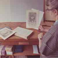 Photo of Stella Patri holding a print from a book