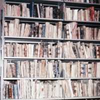 Scan of a slide showing a book case of antique books