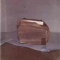 Tail of a book whose leather covering is peeling away