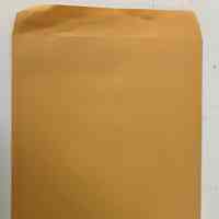 Manilla folder with photos of Patri throughout her life