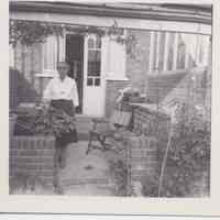 Photo of a woman in front of a house