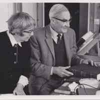 Photo of Stella Patri and an old man examining a book