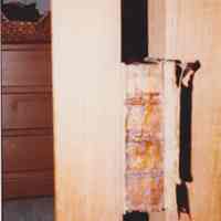 Photo of a damaged book in a finishing press