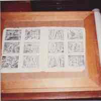 Photo of a folio of prints in a work space