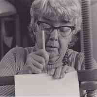 Photo of Patri working at a sewing frame