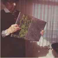 Photo of Stella Patri with a book and book case