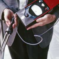 Scan of a photo of someone holding a moisture sensor