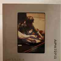 Patri starting to lift a piece of paper