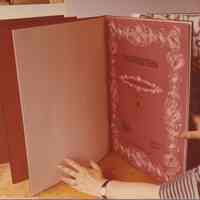 Photo showing a book with held open showing 