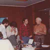 Photo of people standing around the end of a table