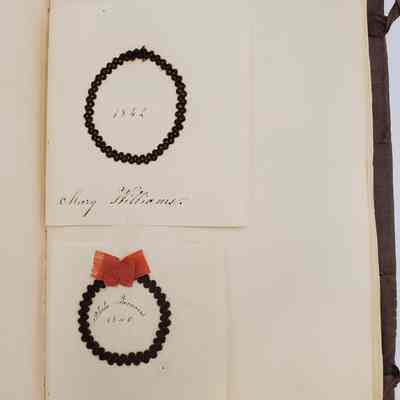 Amy Hall Williams Hair Album 1834-1844: Hair samples from: Mary Williams 1842; Phebe Famous 1840, red bow