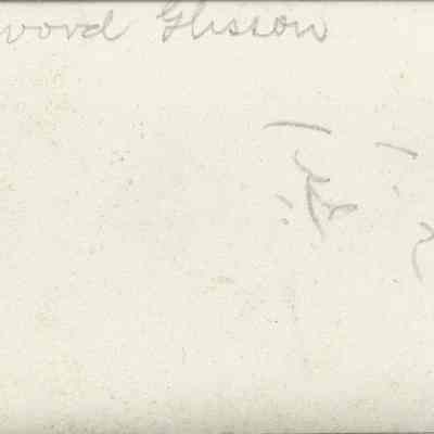 Elwood Glisson at home, seated at desk reading a book, circa 1900s: back of photograph - "Elwood Glisson"