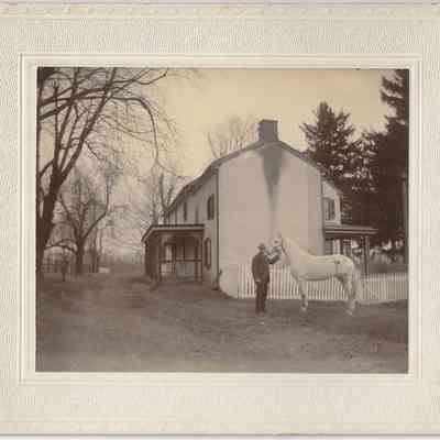 Elwood and Amy Ida Glisson’s house and horse on the farm. “We moved there March 25th 1890”): front of photograph with frame/mount