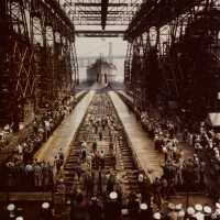 USS Iowa leaving builders slipway into the East River, with the Brooklyn Bridge in the distance. Rare color photo 80-G-K-13514.