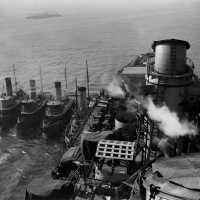 IOWA leaving New York Navy Yard for dry docking with 4 tugs on her aft starboard hull. October 20, 1942 - 80-G-13572