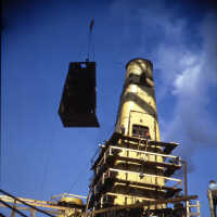 An overhead crane lowers a prefabricated structure onto IOWA for installation. Fall 1942 - 80-G-K-511