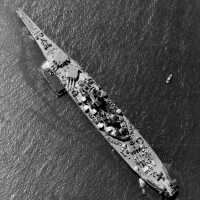 USS Iowa anchored off New York with an ammunition barge tied up on her port. April 7, 1943 - US Navy photo.