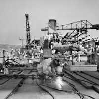 Welding on Forward Main Deck. 16 inch gun Turret 1 & superstructure begins to take shape further aft. October 1942 - 80-G-K-510