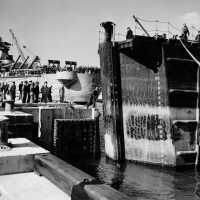 Tug boats push the caisson into its final position to seal the dry dock. October 20, 1942 - 80-G-13560