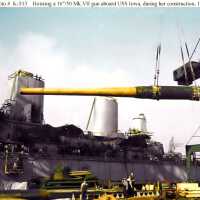 A crane hosts a 16 inch gun barrel onto IOWA for installation. Note the two stacks in the background. Fall 1942 - 80-G-K-513