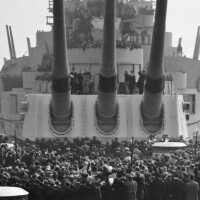 Close up of Commissioning guests watching the ceremony taking place aft of Turret 3. Feb 22, 1943. USN photograph.