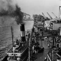 IOWA being towed with tugs forward and on her port hull for dry docking. October 20, 1942 - 80-G-13571
