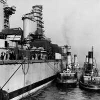 IOWA, with her 16 tug boats, waiting for low tide to pass under the Brooklyn Bridge. October 20, 1942 - 80-G-13585