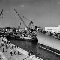 Workers continue to adjust lines to position IOWA over her keel blocks in dry dock. October 20, 1942 - 80-G-13561