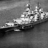 USS Iowa anchored off New York with an ammunition barge tied up at her port quarter. April 7, 1943 - US Navy photo.