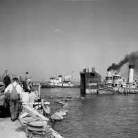 Tug boats begin moving the dry dock caisson into position to close the dock with Iowa inside. October 20, 1942 - 80-G-13559