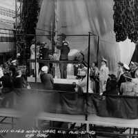 Sponsor Mrs. Wallace breaks a bottle of champagne on battleship Iowa
