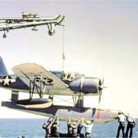 A Kingfisher float plane is being guided back onto its catapult after being craned on board. US Navy photograph.