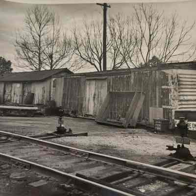Photo of Train Car, Building, Tracks, and Switches