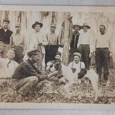 Postcard undated - group of men with hunting dog - note says Robert Yoksh on left with deer head