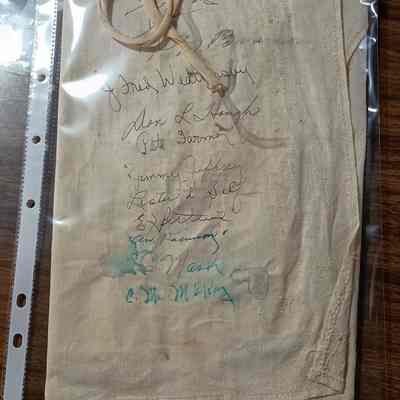 Apron signed by founders of Kiwanis in Silsbee includes copies of signatures on white copy paper