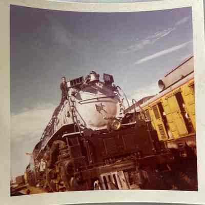 Photo of Man on Train Engine in Railyard by W C Roy
